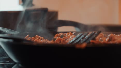 Closeup-of-Steaming-Food-in-Large-Frying-Pan,-Cooking