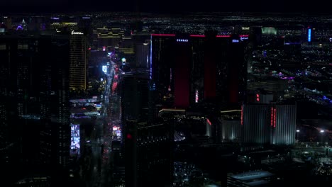 The-Las-Vegas-Strip-downtown-area-at-night,-tilt-up-nighttime-cityscape-background