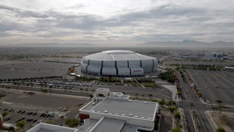 State-Farm-Stadium,-home-of-the-Arizona-Cardinals-National-Football-League-team-in-Glendale,-Arizona-with-drone-video-wides-hot-moving-in