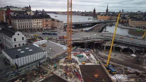 Traffic-on-bridge,-distant-towers-and-construction-site-at-Slussen-in-Stockholm