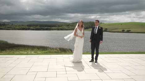 Newly-wed-bride-and-groom-together,-backdrop-picturesque-landscape-and-lake