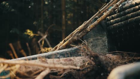 Close-up-of-a-forest-machine-absorbing-a-fallen-tree,-amidst-a-natural-woodland-setting