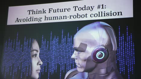 Close-up-of-presentation-screen-with-female-human-face-and-male-robot-face