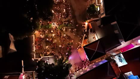 Drone-top-down-bird's-eye-view-pan-across-Kura-Hulanda-village-in-Otrobanda-Willemstad-Curacao-at-night