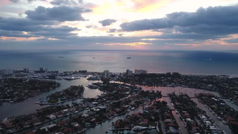 A-colorful,-rising-drone-shot-of-the-Atlantic-Ocean-and-the-coastline-of-Fort-Lauderdale,-Florida-during-sunrise