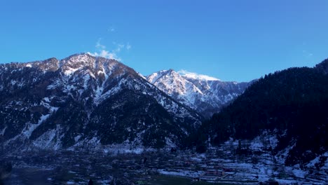 Snow-capped-mountains-under-blue-sky-at-Athmuqam,-Neelum-Valley,-Jammu-Kashmir