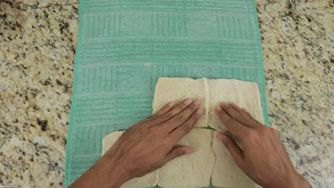 Placing-bread-slices-on-a-towel,-top-down-view