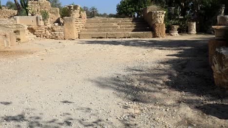 Ancient-Roman-ruins-in-Carthage,-Tunisia-under-clear-blue-sky,-wide-shot