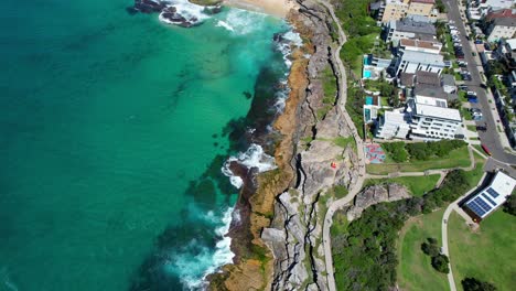 Ocean-Waves-Splashing-Rocky-Shore,-Tamarama-Beach-And-Bronte-Beach-In-Sydney,-NSW,-Australia--Aerial-Drone-Shot