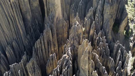 Aerial-looks-down-onto-sharply-eroded-pillars-of-conglomerate-rock
