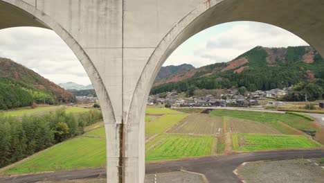 Aerial-Drone-Fly-near-geometrical-cemented-bridge-at-Japanese-countryside-road,-in-Asago-Hyogo,-Countryside-Japan-Village,-agricultural-feel