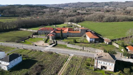 Aerial-ascend-retreating-establishes-monastery-in-scenic-galician-countryside-of-Spain