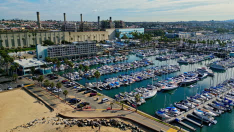 Aerial-view-toward-King-Harbor-marina,-sunny-morning-in-Los-Angeles,-USA