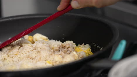 Chef-tosses-crab-egg-and-rice-in-pan-over-flame,-flipping-crab-fried-rice-in-pan,-close-up-slow-motion-4K