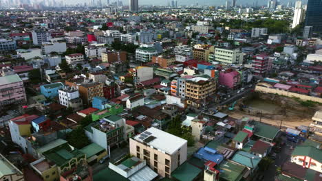 Drone-shot-overlooking-vibrant-homes-in-Makati-city,-sunny-Manila,-Philippines