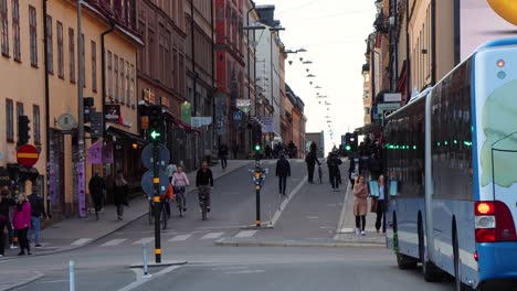 Street-traffic-in-Stockholm,-blue-city-bus-turns-out-of-frame