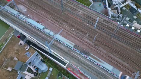 Train-passing-on-railway.-Aerial-top-down-descending