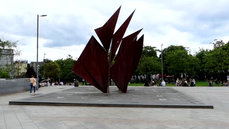 Quincentennial-Fountain-in-Eyre-Square-with-people-around-the-park,-Galway