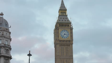 Famous-Big-Ben-clock-tower-landmark-and-lit-lantern-against-cloudy-sky
