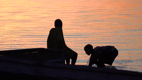 Junge-Jungen-Sammeln-Bei-Sonnenuntergang-Wasser-An-Einem-Afrikanischen-See