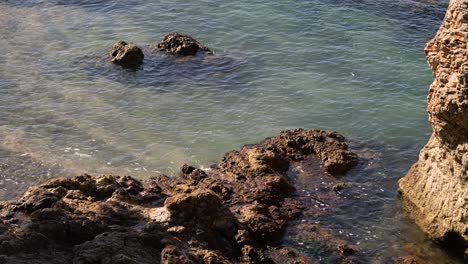 Looking-down-at-turquoise-waters-in-Croatia-with-rocky-beach