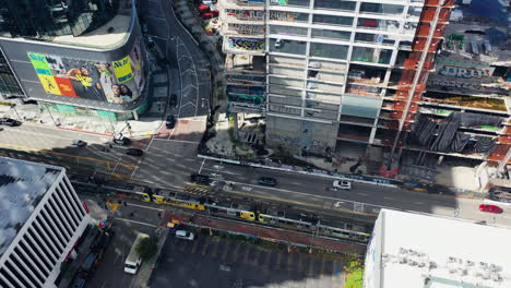 Aerial-view-following-a-tram-in-middle-of-skyscrapers-in-downtown-Los-Angeles