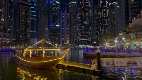 DUBAI,-UAE--04-January-2024:-Night-view-of-Dhow-and-skyscrapers-in-Dubai-Marina---a-residential-neighborhood-and-a-district-in-Dubai,-United-Arab-Emirates