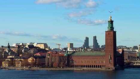 Timelapse-of-Stockholm-City-Hall,-ferry,-cityscape,-clouds-and-traffic