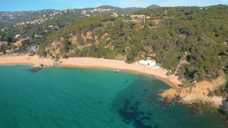 Experience-the-magic-of-Lloret-De-Mar-and-the-pristine-waters-of-Cala-Canyelles,-set-against-the-stunning-backdrop-of-Costa-Brava