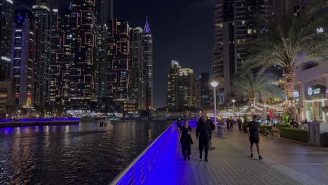 DUBAI,-UAE--04-January-2024:-Night-view-of-Dhow-and-skyscrapers-in-Dubai-Marina---a-residential-neighborhood-and-a-district-in-Dubai,-United-Arab-Emirates