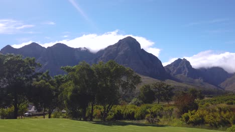 Pan-of-a-Stellenbosch-vineyard-and-surrounding-mountains-under-blue-sky