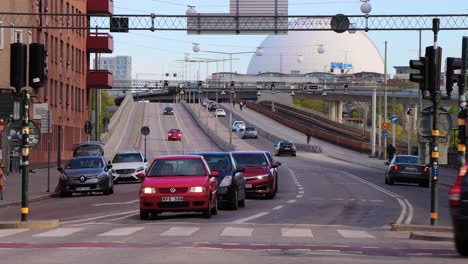 Static-shot-of-car-and-bike-traffic-at-Skanstull-in-Stockholm,-Sweden