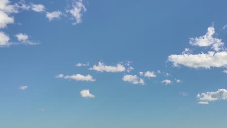 Nice-summer-blue-sky-with-slow-moving-fluffy-white-clouds