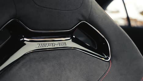 Close-up-of-Mercedes-AMG-Alcantara-seat-design-with-shiny-plastic-and-hole