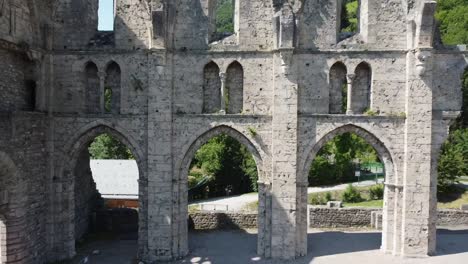 Camera-moves-out-from-old-cathedral-window-to-reveal-ruins