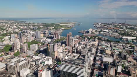 Citadel-port-louis-in-mauritius,-showcasing-the-cityscape-and-coastline-on-a-sunny-day,-wide-shot,-aerial-view