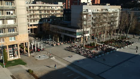 Drone-aerial-view-of-Partisan-Square,-downtown-Uzice,-Serbia-on-sunny-spring-day