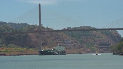 Static-shot-of-ships-sailing-through-the-Panama-Canal-below-Centenario-Bridge