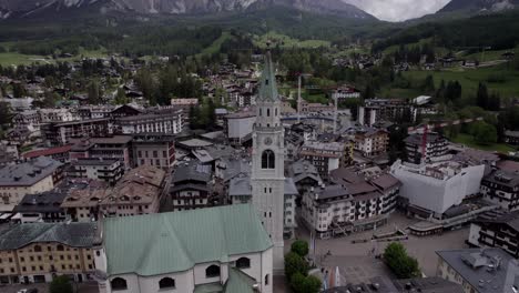 Close-orbit-medieval-clock-tower-Cortina-D'Ampezzo,-Dolomites-Italy