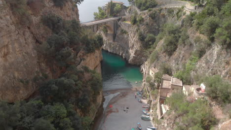 Drone-shot-over-Fiordo-de-Furore,-Italy-on-a-bright-day