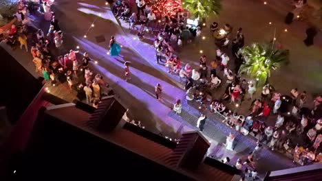 Tracking-aerial-follows-models-showcasing-high-fashion-styles-at-night-in-Kura-Hulanda-village-in-Otrobanda-Willemstad-Curacao