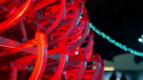 Close-up-of-Sleds-illuminated-with-Red-lights-creating-Art-Christmas-Tree
