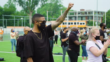 African-American-man-holding-his-fist-up-during-Black-Lives-Matter-protest,-slow