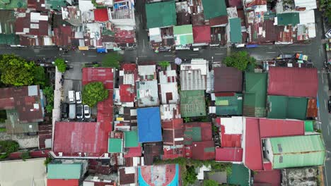 Aerial-top-down-view-of-impoverished-neighborhood-in-San-Juan-City,-Philippines-with-old-rooftops-and-streets