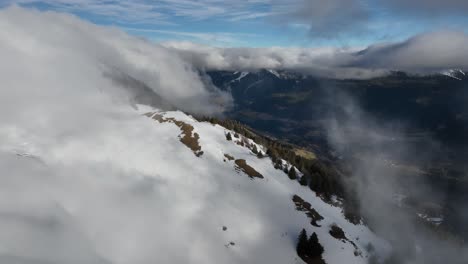 Discovering-a-valley-with-misty-clouds-and-snow,-Chartreuse,-French-Alps