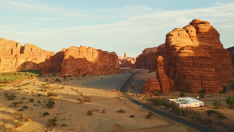 Asphalt-road-with-orange-rocks-and-yellow-sand-on-sunset