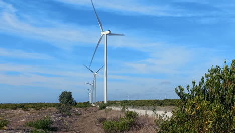 Wind-energy-to-be-produced-on-an-industrial-scale-in-the-dunes-next-to-the-sea,-large-wind-farms