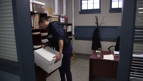 Police-officer-walking-through-precinct-with-case-files
