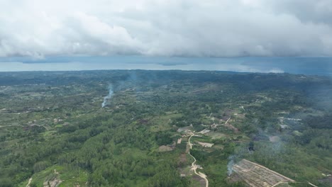 Samosir-island-in-lake-Toba-with-cloudy-skies-and-lush-landscape,-aerial-view