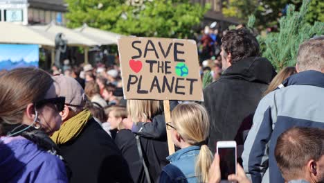 Young-girl-holds-"Save-the-planet"-sign-at-envionmental-rally-in-Stockholm